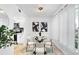 Bright dining room features modern art, a glass table, and seating for four at 408 S Arrawana Ave # B4, Tampa, FL 33609