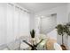Sunlit dining room boasts a glass table, seating for four, and a view into entry way at 408 S Arrawana Ave # B4, Tampa, FL 33609