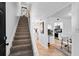 Hallway and staircase lead to upper level and provide easy access to kitchen and dining at 408 S Arrawana Ave # B4, Tampa, FL 33609