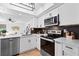 Modern kitchen features stainless steel appliances, quartz countertops, and new backsplash at 408 S Arrawana Ave # B4, Tampa, FL 33609