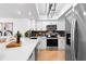 Modern kitchen featuring white cabinetry, stainless steel appliances, and a view into the living area at 408 S Arrawana Ave # B4, Tampa, FL 33609