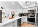 Updated kitchen with a white countertop bar and stylish appliances adjacent to the living area at 408 S Arrawana Ave # B4, Tampa, FL 33609