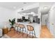 Modern kitchen with white cabinets, stainless steel appliances, and sleek bar seating at 408 S Arrawana Ave # B4, Tampa, FL 33609