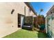 Cozy patio with artificial grass, bench, and privacy fence, creating a charming outdoor living space at 408 S Arrawana Ave # B4, Tampa, FL 33609