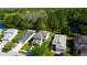 Aerial view of a home with a well-maintained roof, surrounded by lush greenery and other residences at 4250 Warwick Hills Dr, Wesley Chapel, FL 33543