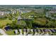 Expansive aerial of a residential community with pools, tennis courts, parks and lush green spaces at 4250 Warwick Hills Dr, Wesley Chapel, FL 33543