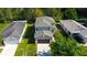 Aerial view of a home surrounded by lush landscaping and neighboring houses at 4250 Warwick Hills Dr, Wesley Chapel, FL 33543
