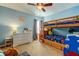 Charming bedroom with blue walls, wooden bunk beds, and a ceiling fan at 4250 Warwick Hills Dr, Wesley Chapel, FL 33543