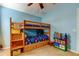 Cozy ' bedroom featuring a wooden bunk bed, colorful decor, and soft carpet at 4250 Warwick Hills Dr, Wesley Chapel, FL 33543