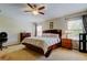 Primary bedroom featuring a large bed, ceiling fan, and natural light at 4250 Warwick Hills Dr, Wesley Chapel, FL 33543