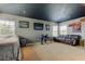 Spacious bonus room featuring a sleek black ceiling, cozy seating, and ample natural light at 4250 Warwick Hills Dr, Wesley Chapel, FL 33543