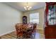 Cozy dining room featuring hardwood floors and an elegant chandelier, perfect for intimate dinners and gatherings at 4250 Warwick Hills Dr, Wesley Chapel, FL 33543