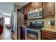 Kitchen featuring stainless appliances, ample counter space, and sleek dark wood cabinetry at 4250 Warwick Hills Dr, Wesley Chapel, FL 33543