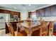 Open-concept kitchen with wooden cabinets, and an island with seating at 4250 Warwick Hills Dr, Wesley Chapel, FL 33543