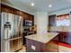 Modern kitchen featuring stainless steel appliances, granite countertops, and rich, dark wood cabinetry for a luxurious feel at 4250 Warwick Hills Dr, Wesley Chapel, FL 33543