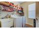 Laundry room equipped with a washer, dryer, sink, and storage shelves at 4250 Warwick Hills Dr, Wesley Chapel, FL 33543