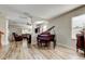 Open-concept living room with new flooring, featuring a grand piano and leather furniture creating a luxurious space at 4250 Warwick Hills Dr, Wesley Chapel, FL 33543