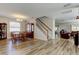 Spacious living area with wood-look floors, dining area, staircase, and comfortable seating, creating an inviting atmosphere at 4250 Warwick Hills Dr, Wesley Chapel, FL 33543