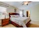 Serene bedroom features a large bed, a ceiling fan, and an en suite bathroom for ultimate comfort and privacy at 4250 Warwick Hills Dr, Wesley Chapel, FL 33543