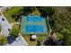 Aerial view of well-maintained tennis courts surrounded by lush greenery and community amenities at 4250 Warwick Hills Dr, Wesley Chapel, FL 33543