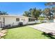 Well-maintained backyard with artificial turf, stone pathway, and white exterior at 4846 Highland S St, St Petersburg, FL 33705