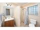 Bathroom featuring a shower, toilet and updated vanity sink and mirror at 4846 Highland S St, St Petersburg, FL 33705