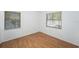This bedroom features hardwood floors, natural light from two windows, and neutral walls at 4846 Highland S St, St Petersburg, FL 33705
