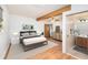 Bright bedroom with an ensuite bath, a wood beam, and laminate wood flooring at 4846 Highland S St, St Petersburg, FL 33705