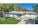 Attractive single-story house featuring a neat lawn, extended driveway, and coordinated green accents at 4846 Highland S St, St Petersburg, FL 33705