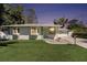 Charming single-story home with well-manicured lawn and a lovely garden bed leading to the front door at 4846 Highland S St, St Petersburg, FL 33705