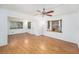 Clean living room showcasing hardwood floors, natural light from large windows, and neutral walls at 4846 Highland S St, St Petersburg, FL 33705