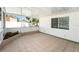 Bright sunroom featuring neutral tile floors, a white ceiling, and a decorative flower bed at 4846 Highland S St, St Petersburg, FL 33705