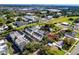 Aerial shot features townhomes, pool, landscaping and the surrounding neighborhood and industrial area at 5502 Liberty Plain Cir, Tampa, FL 33611