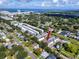 Wide aerial shot showing the entire townhome community, surrounding neighborhood and distant waterfront at 5502 Liberty Plain Cir, Tampa, FL 33611