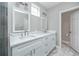Bathroom featuring a double vanity with marble countertops and framed mirrors, and tiled walls at 5502 Liberty Plain Cir, Tampa, FL 33611