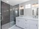 Bathroom with a modern glass-enclosed shower and double vanity at 5502 Liberty Plain Cir, Tampa, FL 33611
