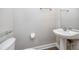 Modern half-bathroom with pedestal sink, toilet and floating glass shelf at 5502 Liberty Plain Cir, Tampa, FL 33611