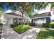 Community clubhouse features a covered porch and adjacent mail center, all surrounded by lush landscaping at 5502 Liberty Plain Cir, Tampa, FL 33611