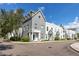 Eye-level shot of modern townhome featuring neutral-toned exterior paint and manicured landscaping at 5502 Liberty Plain Cir, Tampa, FL 33611
