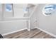 Hallway features wood floors and a round window allowing ample light at 5502 Liberty Plain Cir, Tampa, FL 33611
