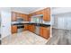 Stylish kitchen with stainless steel appliances, granite countertops, and wood cabinets that opens to living area at 5502 Liberty Plain Cir, Tampa, FL 33611