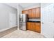 Well-equipped kitchen featuring stainless steel refrigerator, granite countertops, and wood cabinets at 5502 Liberty Plain Cir, Tampa, FL 33611