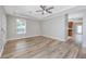 Bright living room with hardwood floors, ceiling fan, and neutral color scheme; opens to kitchen at 5502 Liberty Plain Cir, Tampa, FL 33611