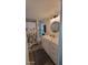 Bright bathroom with walk-in shower and integrated shelving for towels and toiletries, with white vanity at 585 Sky Harbor Dr # 120, Clearwater, FL 33759