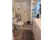Bright bathroom with walk-in shower and integrated shelving for towels and toiletries, with white vanity at 585 Sky Harbor Dr # 120, Clearwater, FL 33759