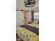 Comfortable bedroom featuring a decorative bedspread, dark curtains, and closet with shelving at 585 Sky Harbor Dr # 120, Clearwater, FL 33759