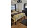 Comfortable bedroom featuring a decorative bedspread, dark curtains, and closet with shelving at 585 Sky Harbor Dr # 120, Clearwater, FL 33759