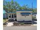 Charming mobile home with blue trim, featuring well-maintained landscaping and an inviting entrance at 585 Sky Harbor Dr # 120, Clearwater, FL 33759