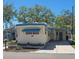 Inviting mobile home with covered parking and landscaped entrance, offering a cozy curb appeal at 585 Sky Harbor Dr # 120, Clearwater, FL 33759