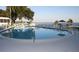 Inviting outdoor pool with chairs and a serene waterfront view, perfect for relaxation and recreation at 585 Sky Harbor Dr # 120, Clearwater, FL 33759